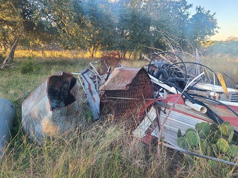 The blind: an old pile of junk metal at the edge of the south field, thirty yards past the junipers.